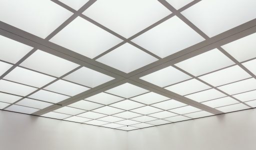 A low angle shot of the ceiling of a building made of square frames